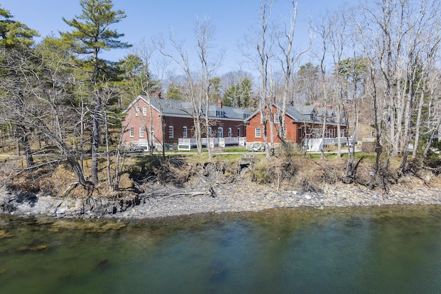 rear view of property with a water view