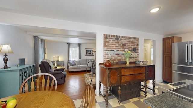 interior space featuring dark countertops, open floor plan, light wood-type flooring, and freestanding refrigerator