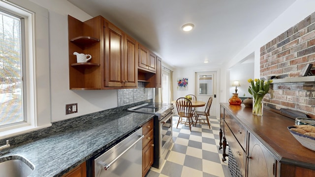 kitchen with light floors, stainless steel appliances, a healthy amount of sunlight, and open shelves