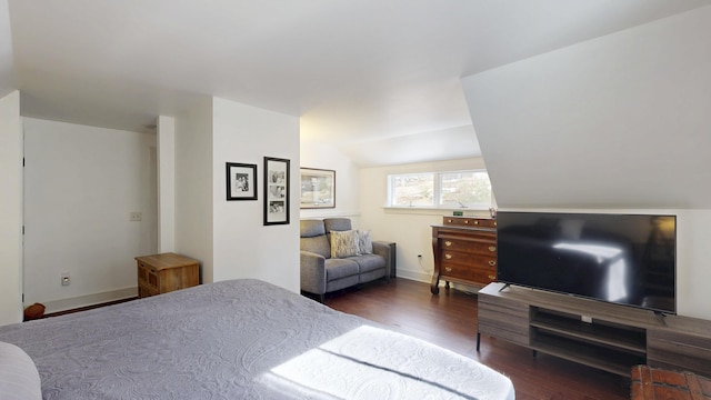 bedroom featuring baseboards, lofted ceiling, and wood finished floors