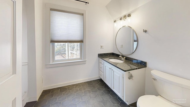 bathroom with tile patterned floors, baseboards, toilet, and vanity