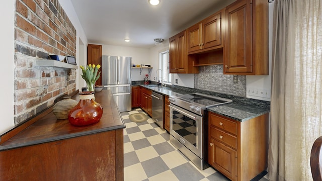 kitchen featuring light floors, open shelves, a sink, stainless steel appliances, and brown cabinets