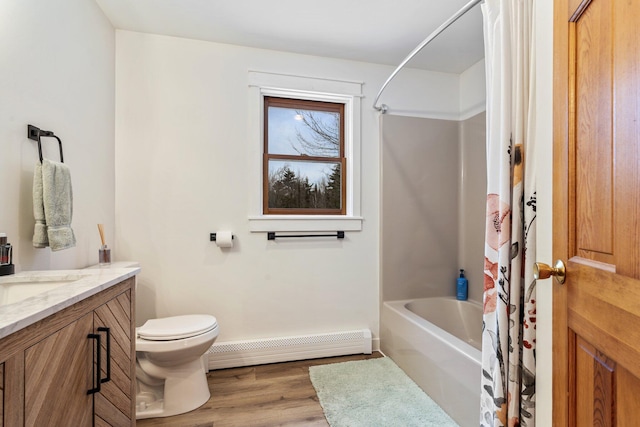 full bathroom featuring vanity, shower / bathtub combination with curtain, wood finished floors, a baseboard radiator, and toilet