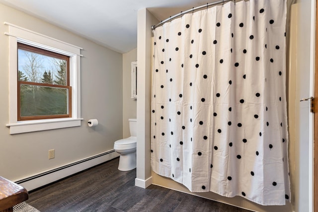 full bathroom with a baseboard heating unit, toilet, and wood finished floors