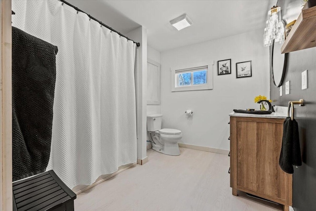 full bathroom featuring vanity, wood finished floors, baseboards, curtained shower, and toilet