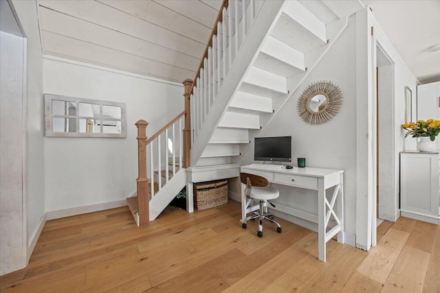 home office featuring baseboards and wood-type flooring