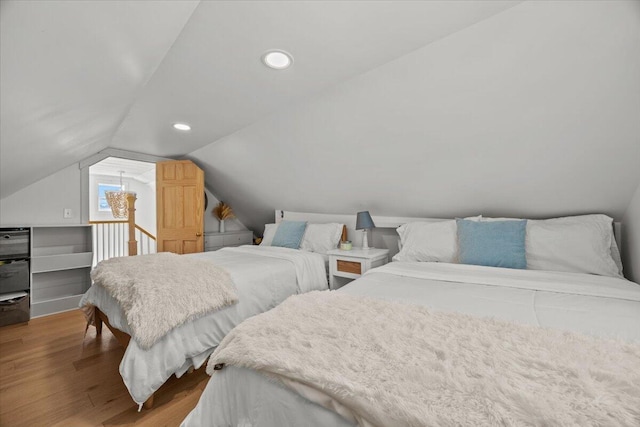 bedroom featuring recessed lighting, lofted ceiling, and wood finished floors