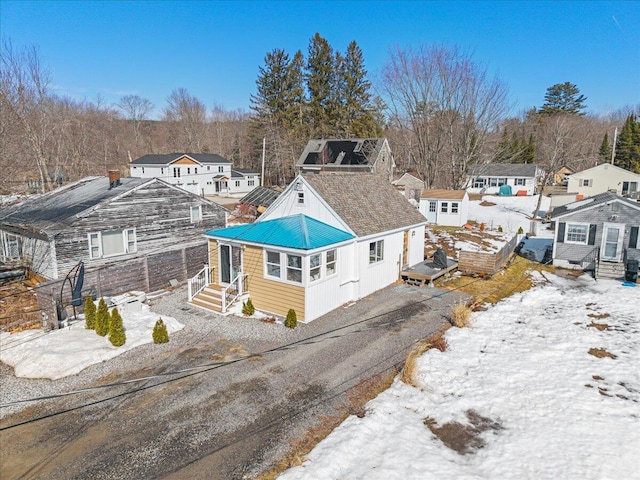 snowy aerial view with a residential view