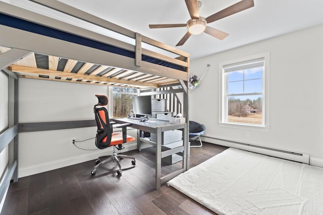 office space with a baseboard radiator, baseboards, wood finished floors, and a ceiling fan