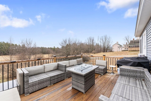 deck featuring an outdoor living space with a fire pit and a grill