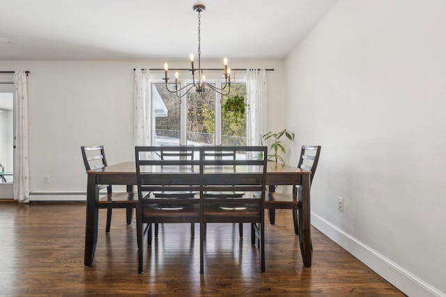 dining room with dark wood-style floors, baseboards, and a chandelier