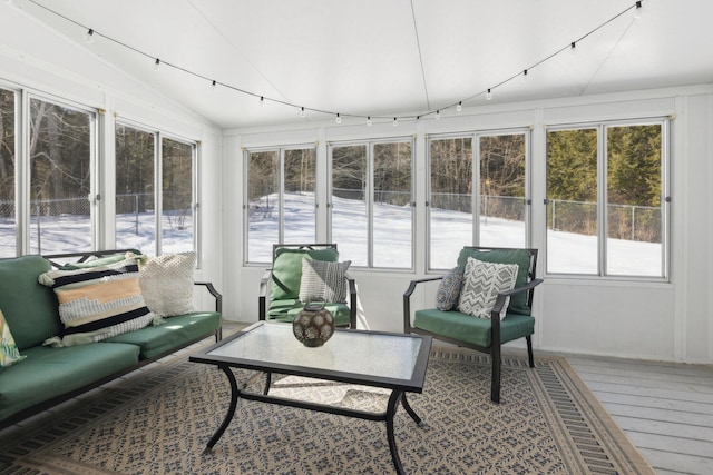 sunroom / solarium with lofted ceiling and rail lighting