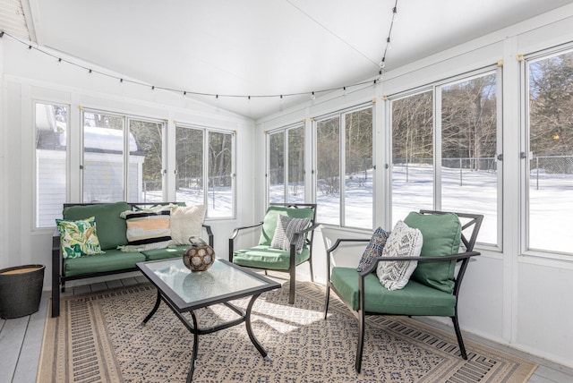 sunroom with rail lighting and a healthy amount of sunlight