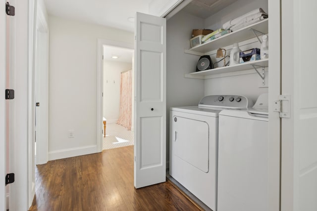 washroom featuring dark wood finished floors, laundry area, baseboards, and independent washer and dryer