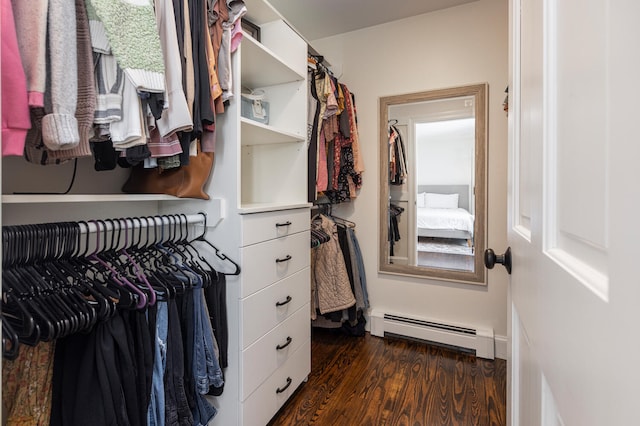 spacious closet featuring dark wood-type flooring and baseboard heating