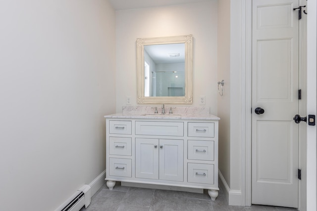 full bath featuring walk in shower, vanity, a baseboard heating unit, and baseboards