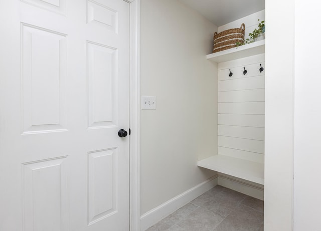 mudroom with light tile patterned floors and baseboards