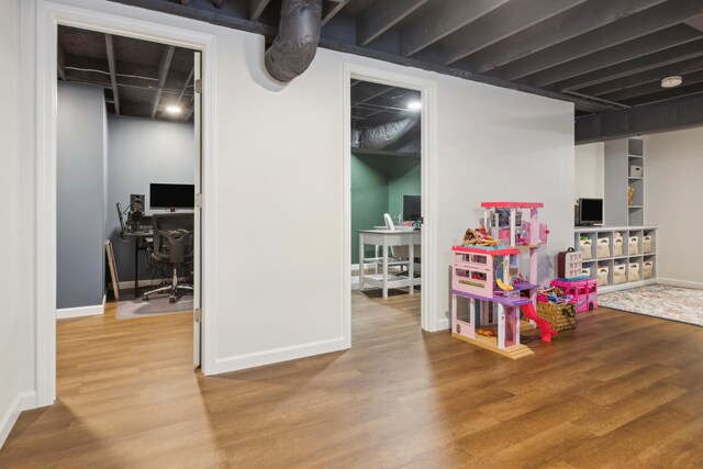 game room featuring wood finished floors and baseboards