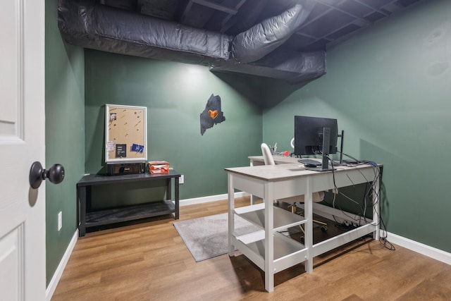 office area with baseboards and wood finished floors