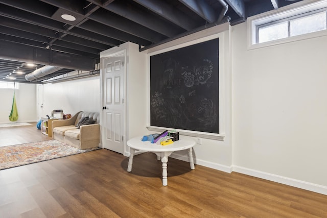 basement with wood finished floors and baseboards