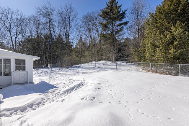 yard layered in snow featuring fence