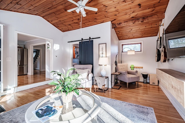 living room featuring a barn door, wood ceiling, wood finished floors, and vaulted ceiling