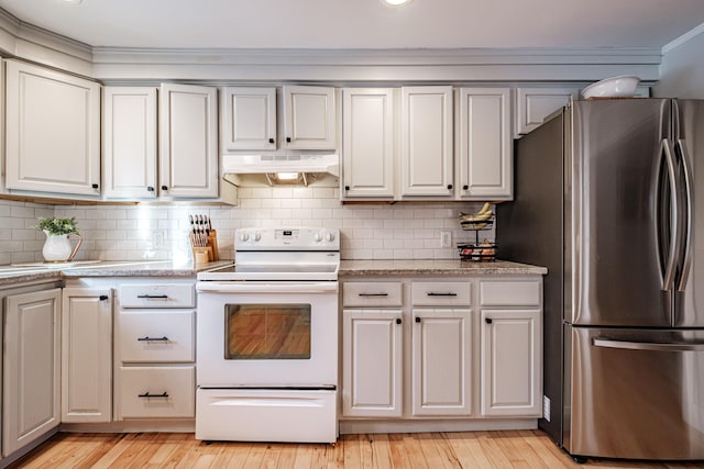 kitchen with white electric range oven, light countertops, freestanding refrigerator, and under cabinet range hood