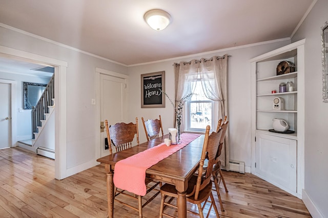 dining room featuring crown molding, stairway, light wood-type flooring, and baseboard heating