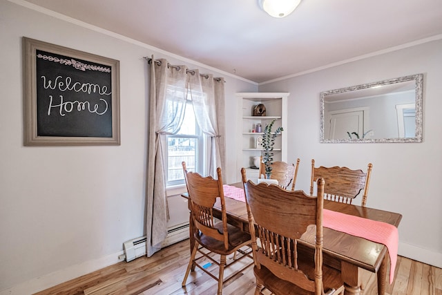 dining space with a baseboard radiator, baseboards, ornamental molding, and light wood finished floors