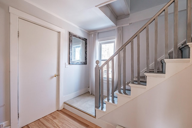 foyer entrance featuring stairway and wood finished floors