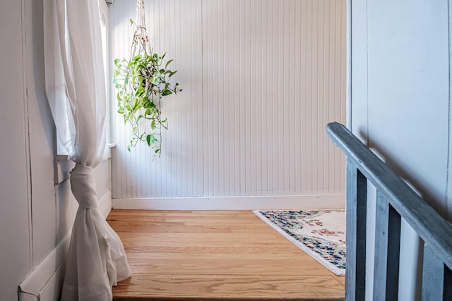 entryway featuring baseboards and wood finished floors