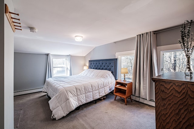 bedroom featuring a baseboard heating unit, carpet, and vaulted ceiling