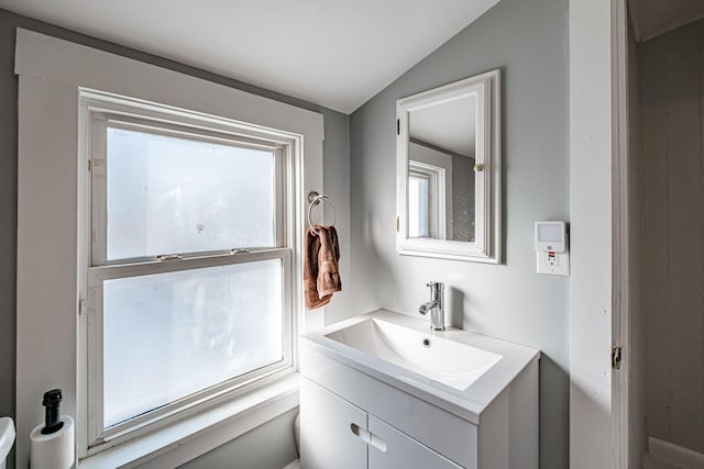 bathroom featuring vanity and vaulted ceiling