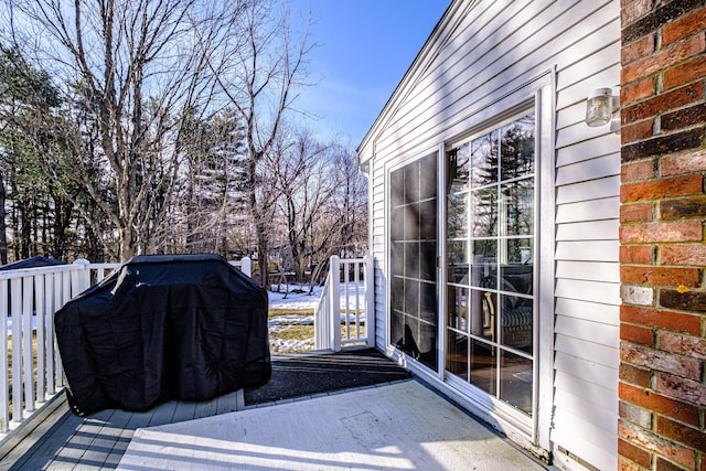 wooden terrace with a grill