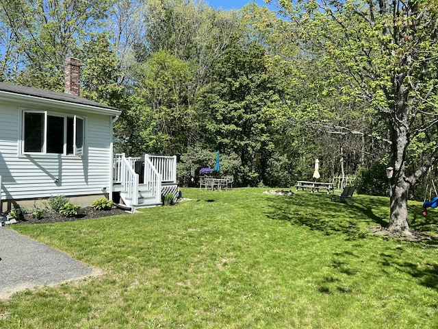 view of yard featuring a wooden deck