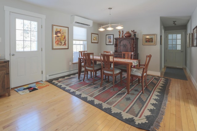 dining area with a wall mounted air conditioner, hardwood / wood-style floors, a baseboard heating unit, a notable chandelier, and baseboards