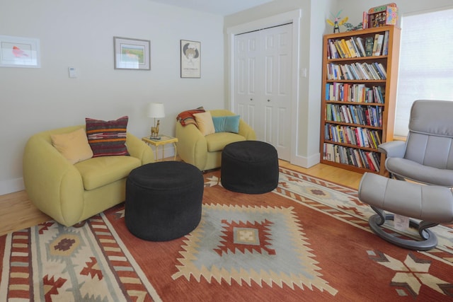 sitting room with wood finished floors and baseboards