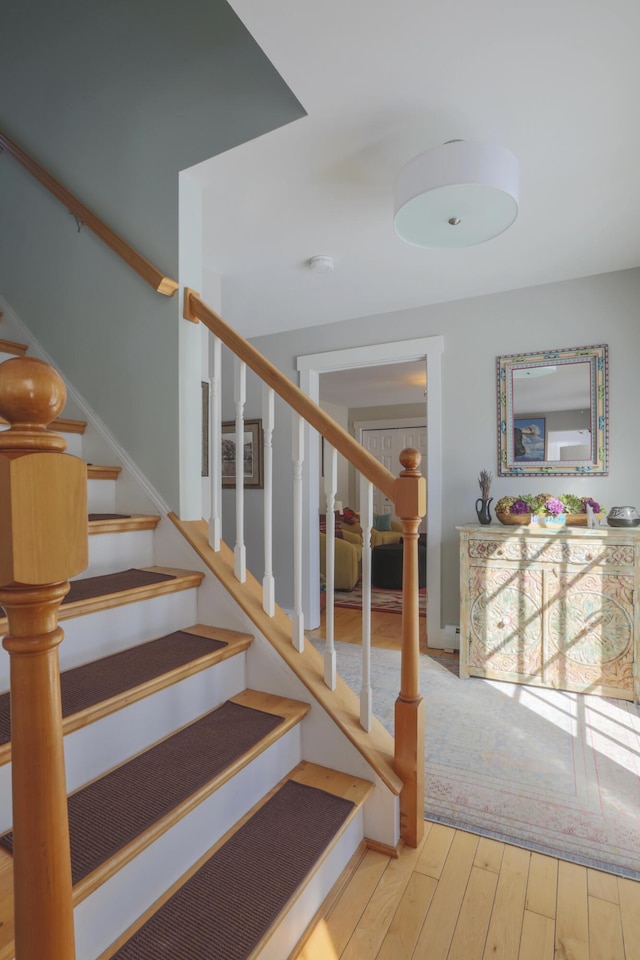 stairs featuring hardwood / wood-style flooring