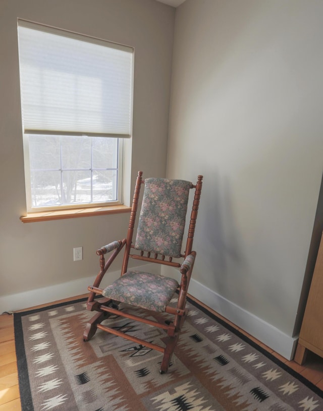 sitting room with wood finished floors and baseboards