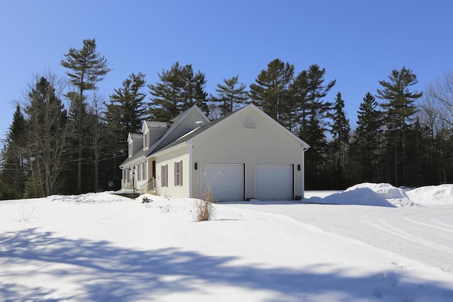 view of snowy exterior featuring a garage