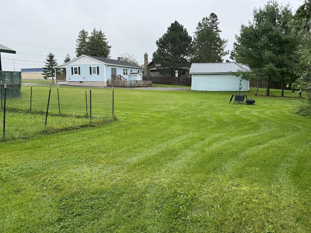 view of yard with a wooden deck and fence