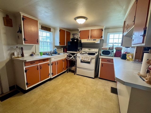 kitchen featuring light floors, a sink, extractor fan, light countertops, and white range with electric stovetop