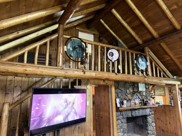 interior space with a fireplace, beamed ceiling, and wood ceiling