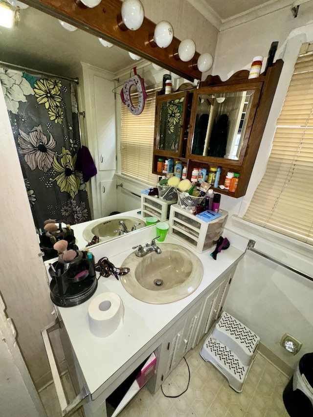 bathroom with tile patterned floors, vanity, crown molding, and a shower with curtain