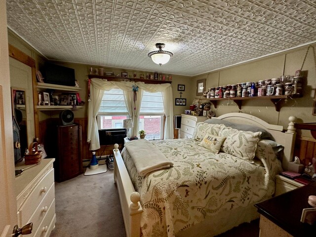 carpeted bedroom with an ornate ceiling