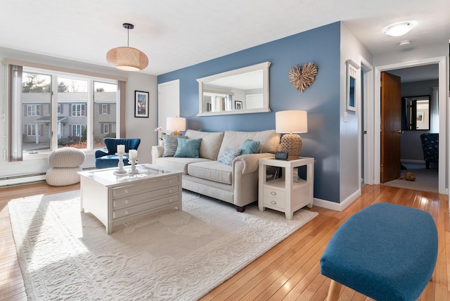 living room featuring light wood-style flooring and baseboards