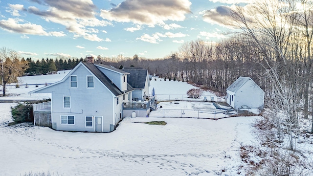 exterior space with a garage and a chimney