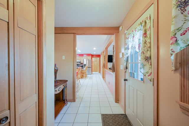 hall with light tile patterned floors