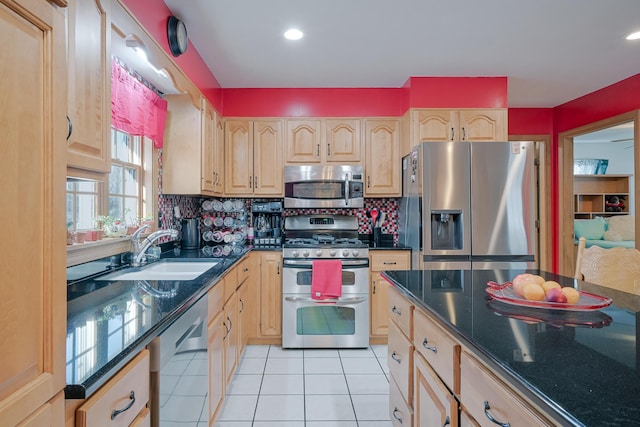 kitchen featuring a sink, stainless steel appliances, backsplash, and light brown cabinetry