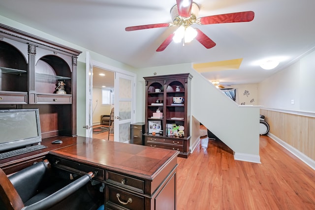 office with ceiling fan, light wood-style flooring, and wainscoting